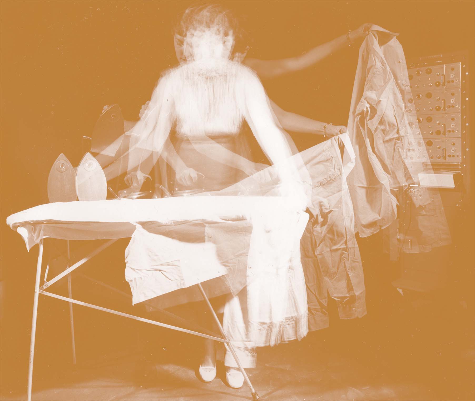 Sepia image of a woman ironing clothes on an ironing board. Image has a long exposure to show movement